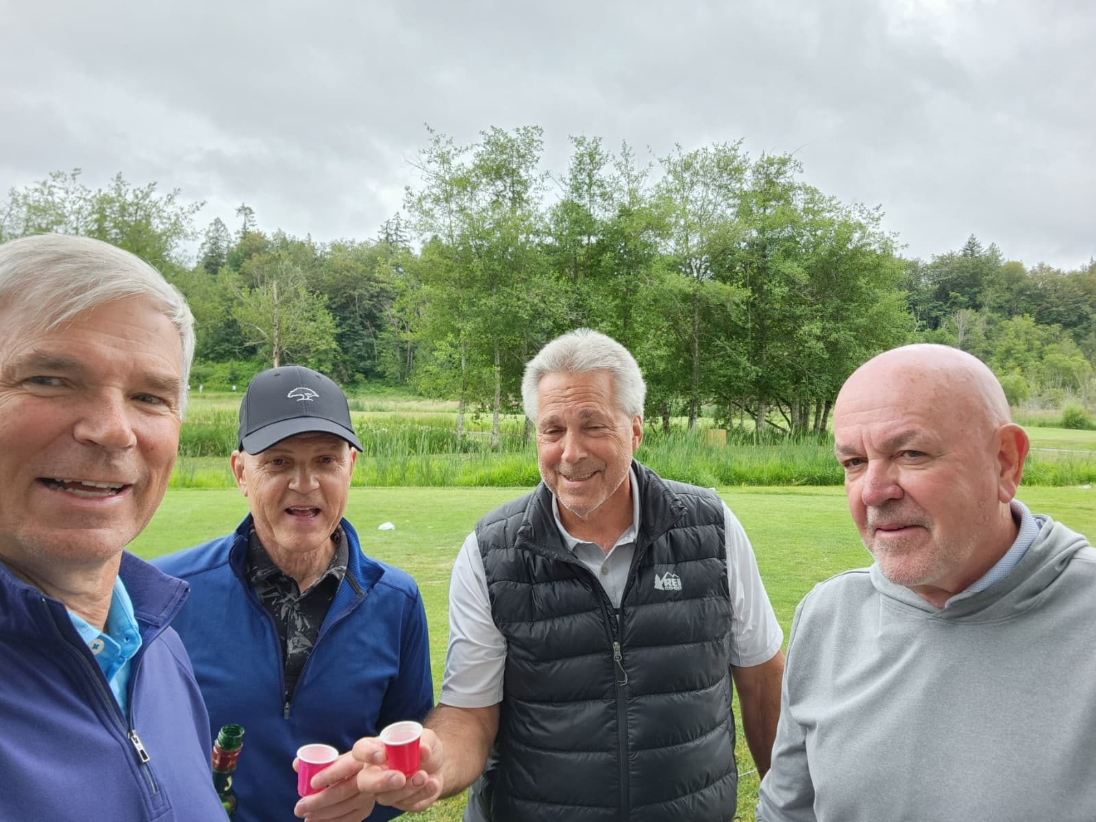 Foursome raising shot cups
